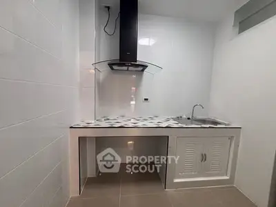 Modern kitchen with sleek design and built-in range hood