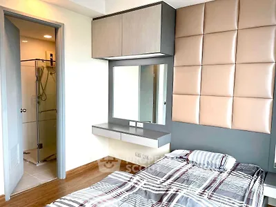 Modern bedroom with stylish decor and ensuite bathroom in a contemporary apartment.