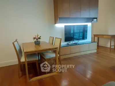 Modern living room with wooden furniture and mounted TV, perfect for cozy gatherings.