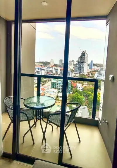 Stunning balcony view with modern furniture overlooking city skyline, perfect for urban living.