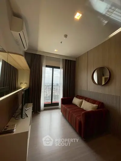 Modern living room with stylish decor and city view from large window.