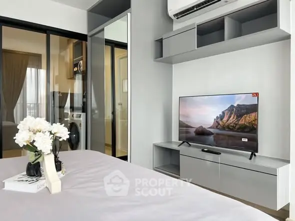 Modern bedroom with sleek TV setup and stylish decor