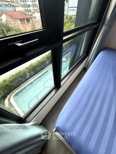 Modern high-rise apartment with pool view from bedroom window