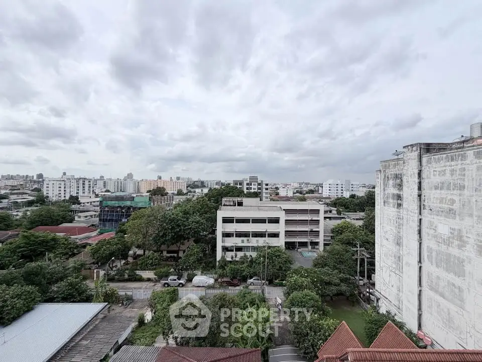 Panoramic cityscape view showcasing urban residential buildings and lush greenery.