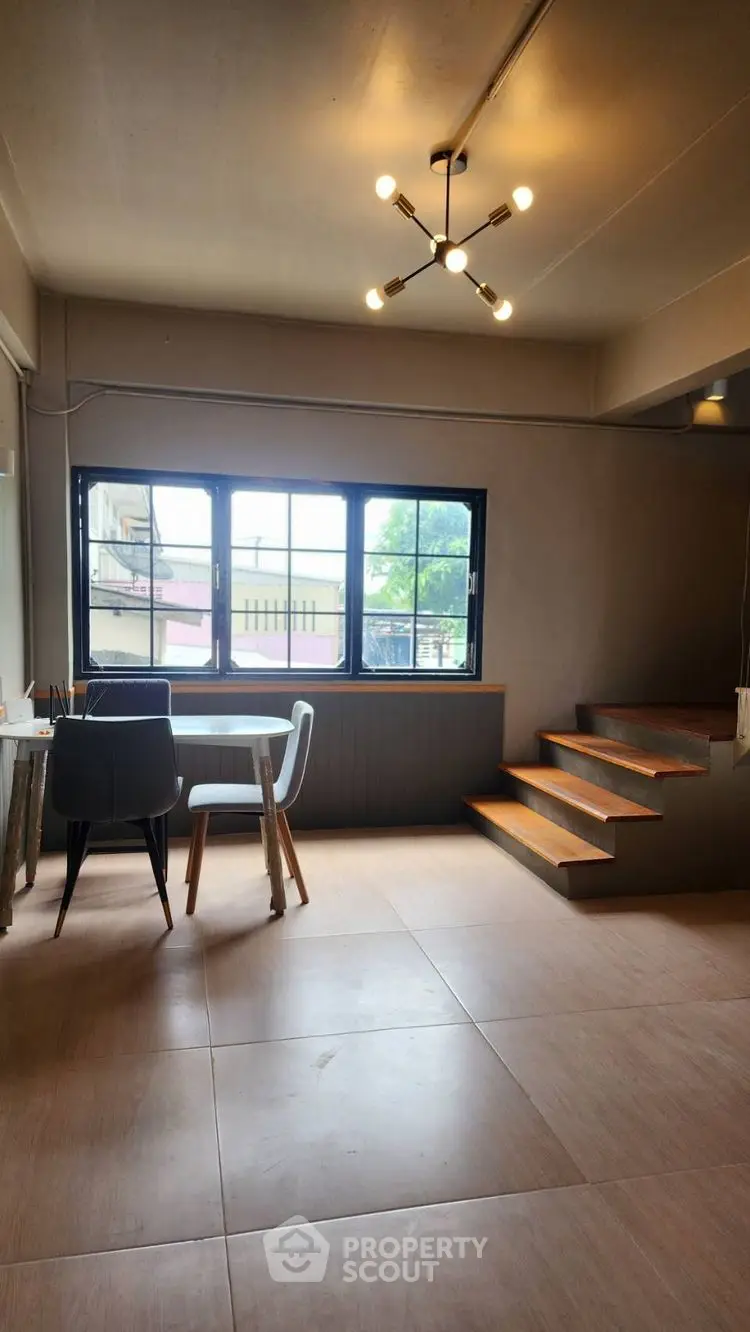 Modern living room with stylish lighting and large windows for natural light.