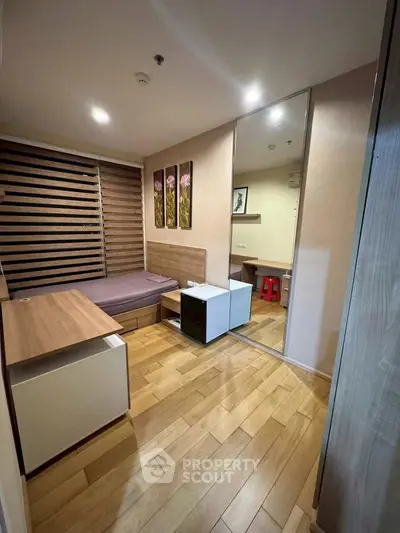 Modern bedroom with wooden flooring and stylish decor