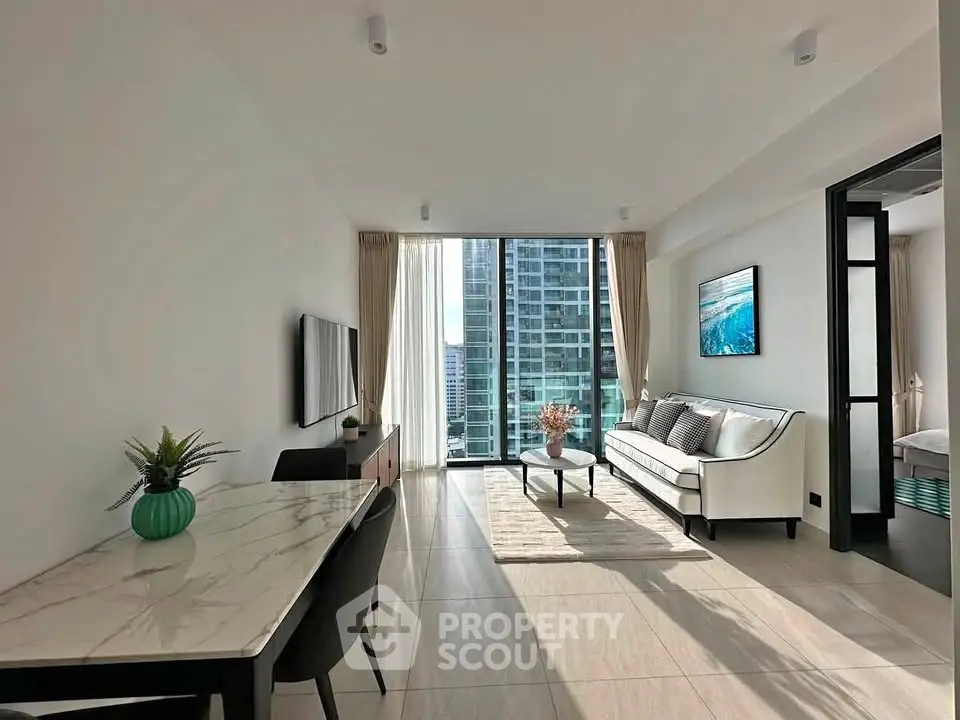 Modern living room with city view, elegant decor, and natural light in luxury apartment.