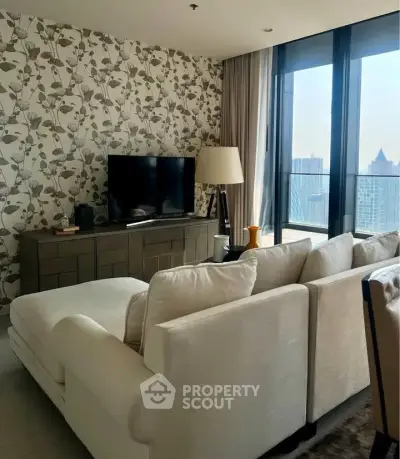 Stylish living room with modern decor and city view, featuring a cozy sofa and elegant wallpaper.