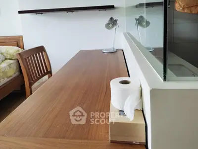 Cozy bedroom with wooden furniture and modern desk setup, perfect for a comfortable living space.