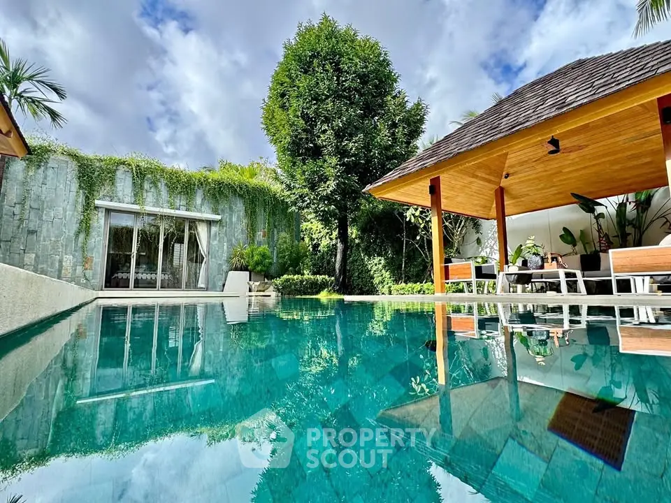 Luxurious villa with private pool and lush garden, perfect for relaxation and tropical living.
