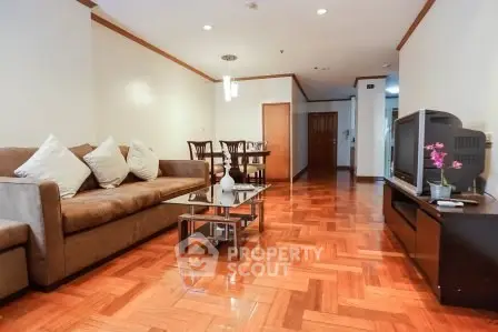Spacious living room with elegant wooden flooring and modern furnishings.