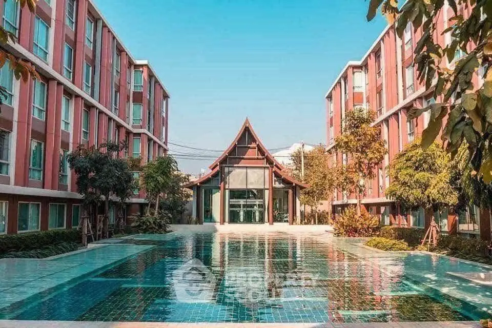Stunning apartment complex with a central pool and unique architectural design.