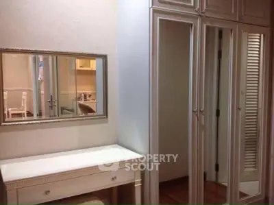 Elegant bedroom with mirrored wardrobe and vanity desk
