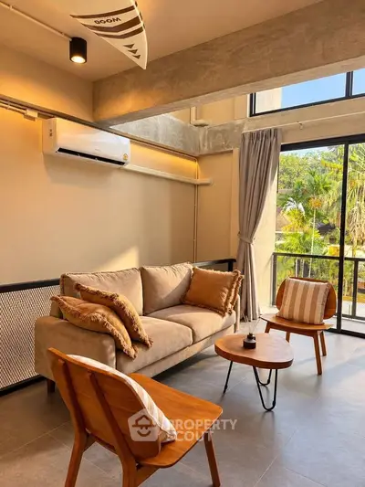 Modern living room with stylish furniture and large windows offering natural light and garden view.