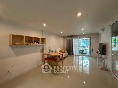 Spacious living room with modern decor and large windows for natural light.