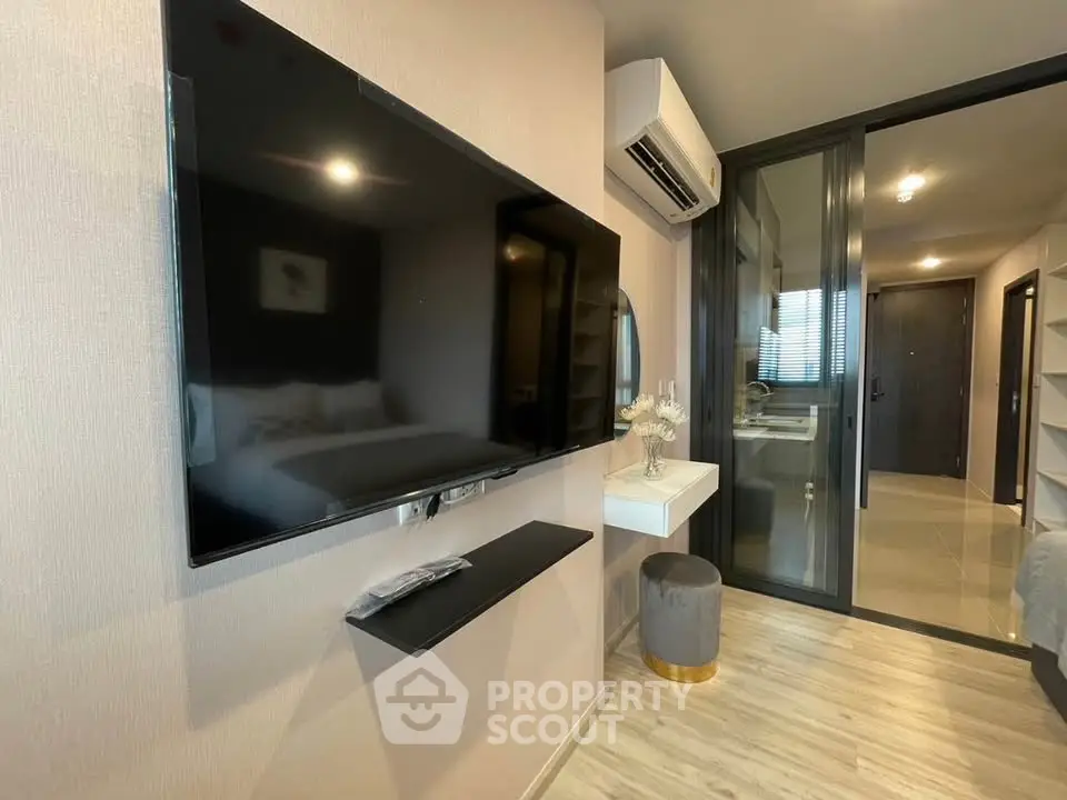 Modern apartment interior with wall-mounted TV and sleek decor