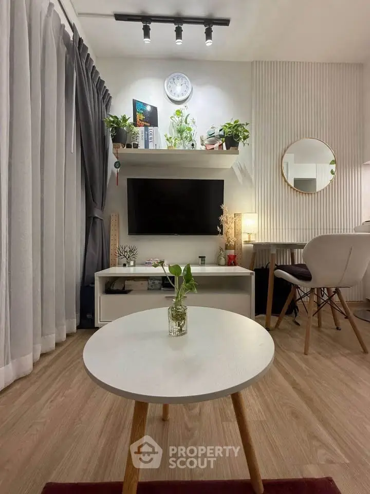 Modern living room with stylish decor, wooden flooring, and cozy ambiance.