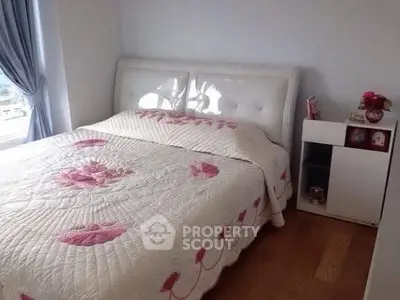 Cozy bedroom with elegant floral bedding and natural light