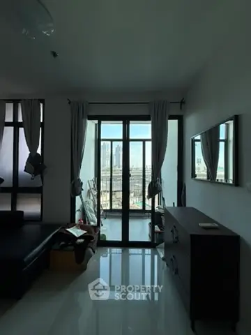 Modern living room with large windows and city view, sleek furniture and minimalist decor.