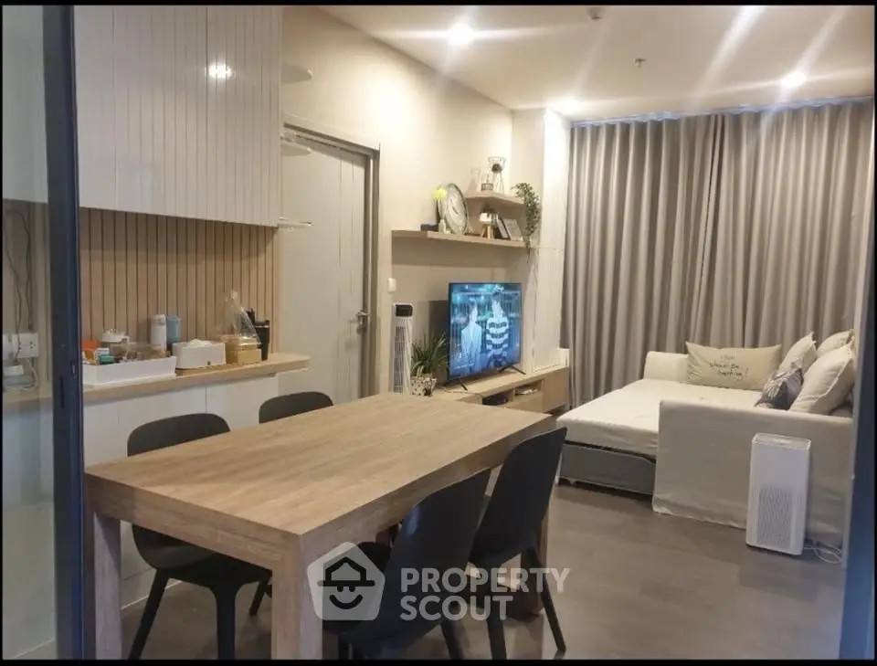 Modern living room with dining area, stylish furniture, and cozy ambiance in a contemporary apartment.