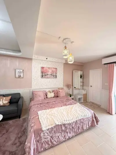 Charming bedroom with elegant decor and cozy ambiance, featuring a plush bed and stylish lighting.