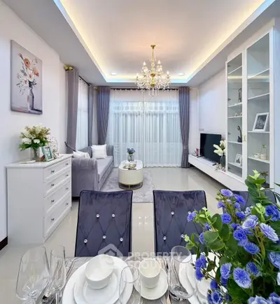 Elegant living room with chandelier, plush seating, and modern decor