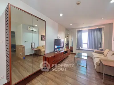 Spacious modern living room with wooden flooring and stylish furniture