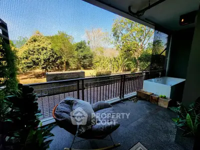Spacious balcony with lush garden view and cozy seating area