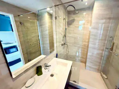 Modern bathroom with glass shower and sleek fixtures in a contemporary apartment.