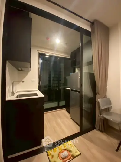 Modern compact kitchen with open layout and balcony access