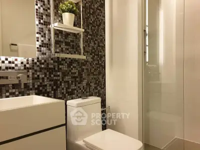 Modern bathroom with mosaic tile accent wall and sleek fixtures