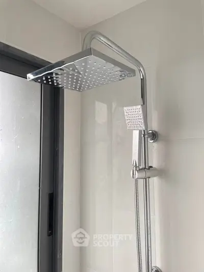 Modern bathroom shower with sleek chrome fixtures and rainfall showerhead.