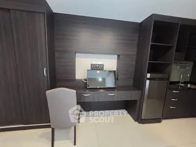 Modern study area with sleek desk, chair, and built-in storage in stylish apartment.