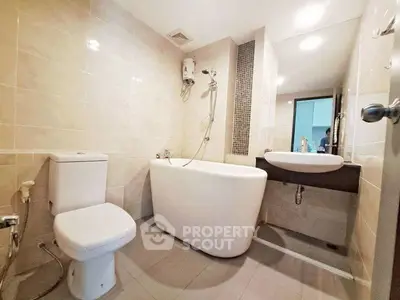 Modern bathroom with sleek fixtures and a stylish bathtub in a contemporary apartment.