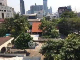 Stunning cityscape view from a lush garden rooftop in urban setting.