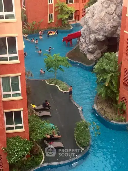 Luxurious apartment complex with stunning pool and rock waterfall feature.