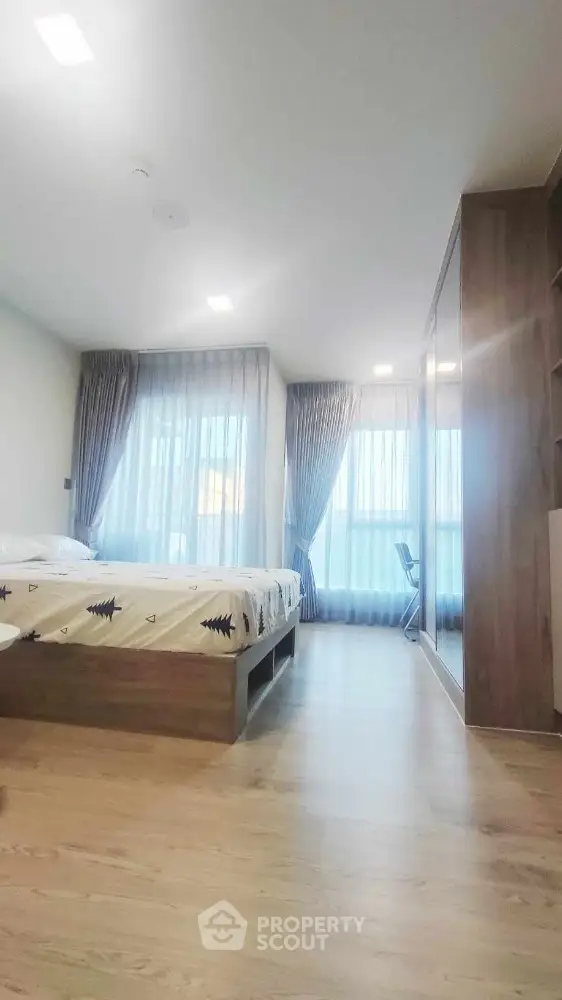 Spacious modern bedroom with large windows and stylish decor