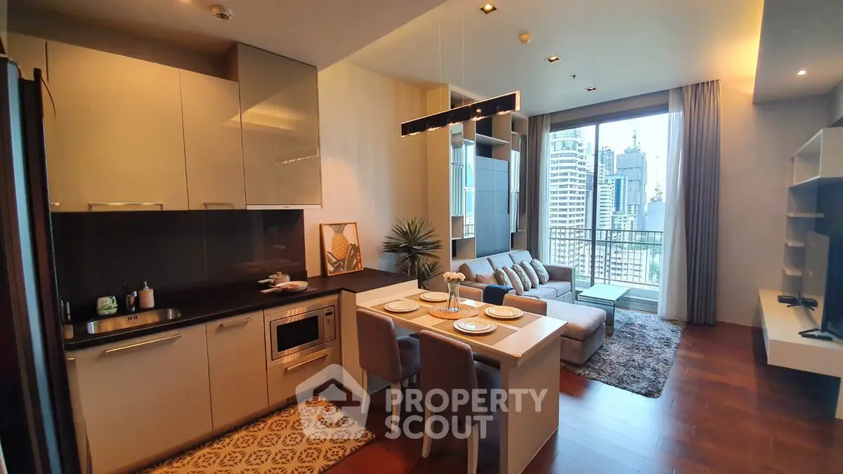 Modern open-plan kitchen and living room with city view balcony in luxury apartment.