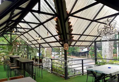 Charming outdoor balcony with rustic decor and lush greenery views