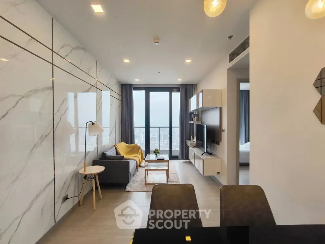 Modern living room with marble walls and city view balcony in luxury apartment