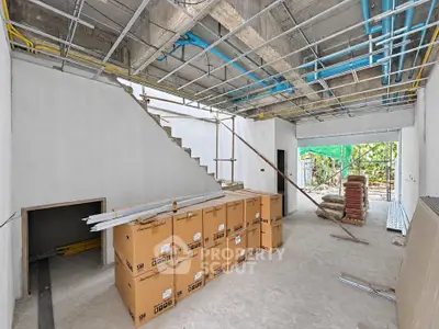 Under-construction interior with exposed pipes and boxes, showcasing renovation potential.