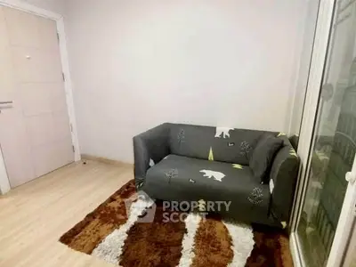 Cozy small living room with stylish sofa and plush rug