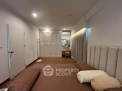 Spacious bedroom with modern decor and ample natural light