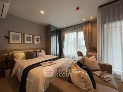 Luxurious bedroom with elegant decor and large windows offering natural light
