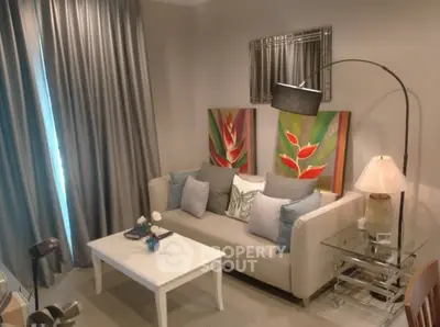 Chic living room with modern decor, featuring a cozy sofa, stylish artwork, and elegant lighting.