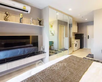 Modern bedroom with mirrored closet and in-room washing machine