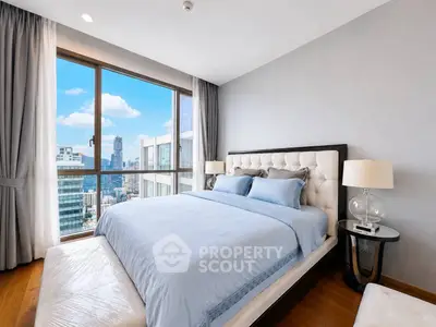 Luxurious bedroom with stunning city view and elegant decor in high-rise apartment.