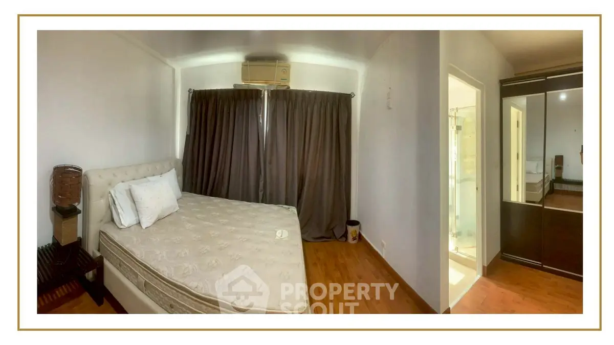 Spacious bedroom with elegant decor and ample natural light, featuring a comfortable bed and stylish wardrobe.