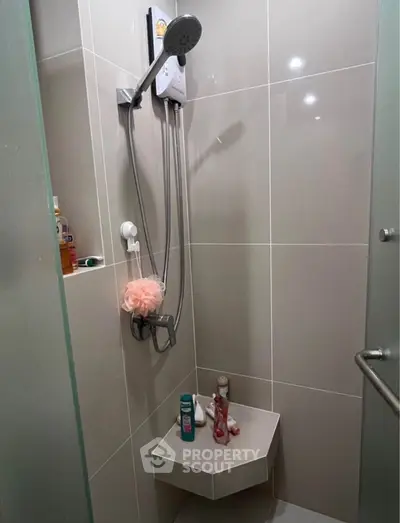 Modern bathroom shower area with sleek tiles and showerhead