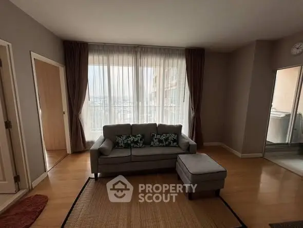 Spacious living room with cozy sofa and natural light